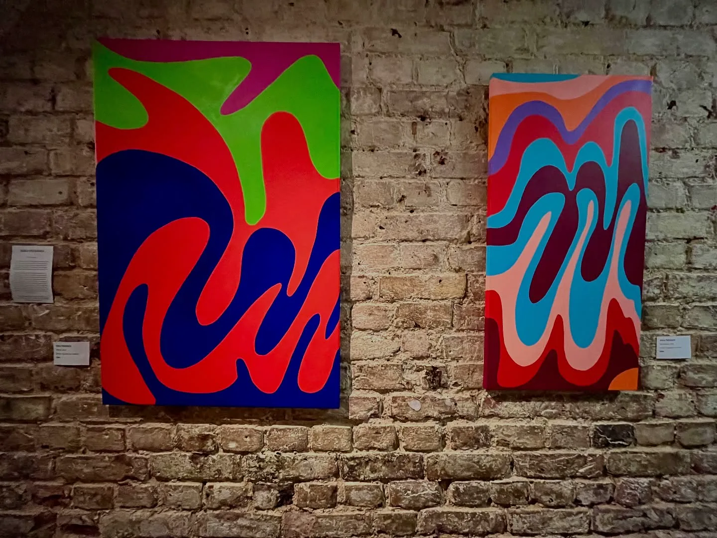 Abstract paintings on a gallery wall at EXI