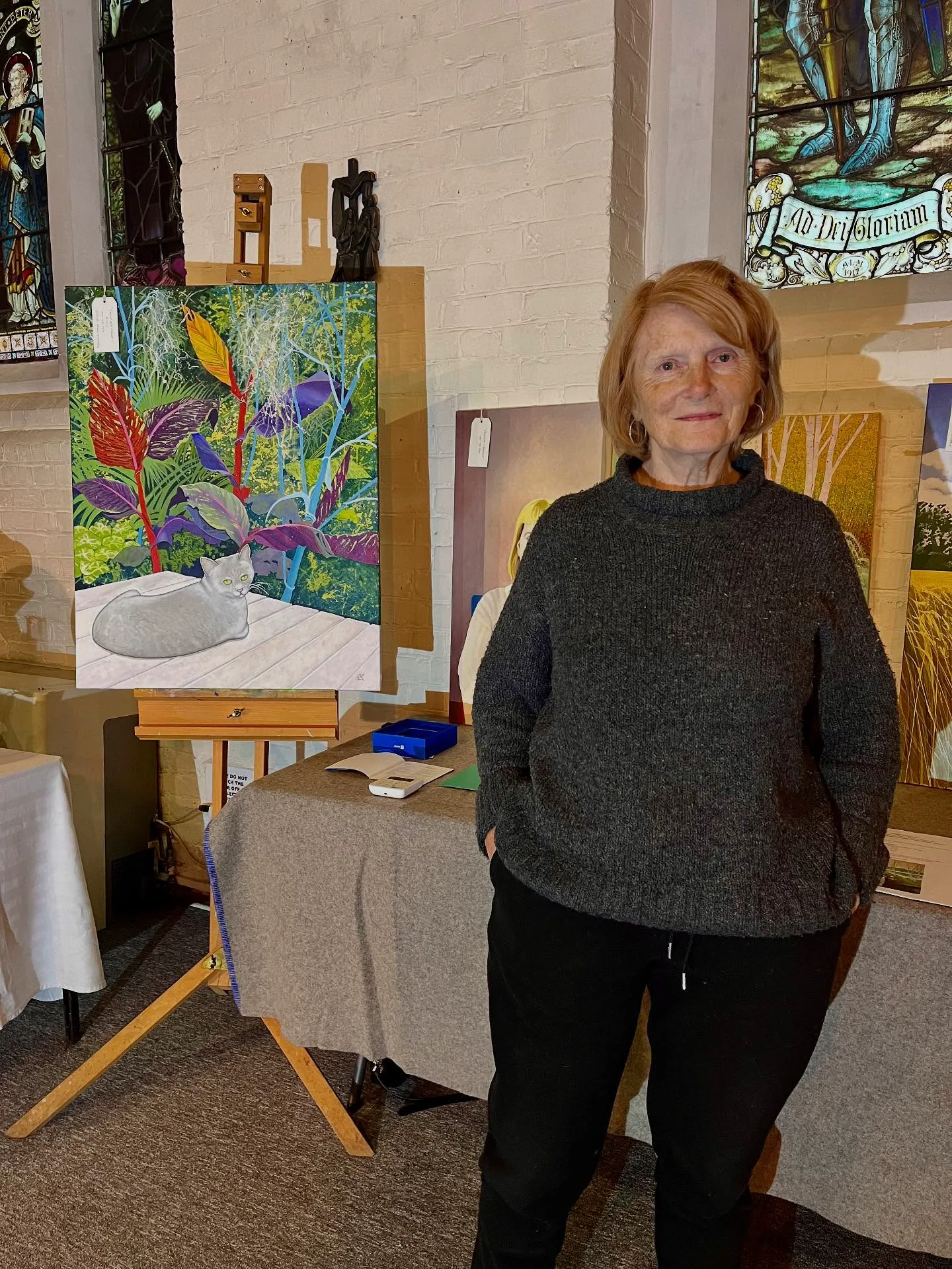 Artist beside a cat painting at Crouch End Open Studios