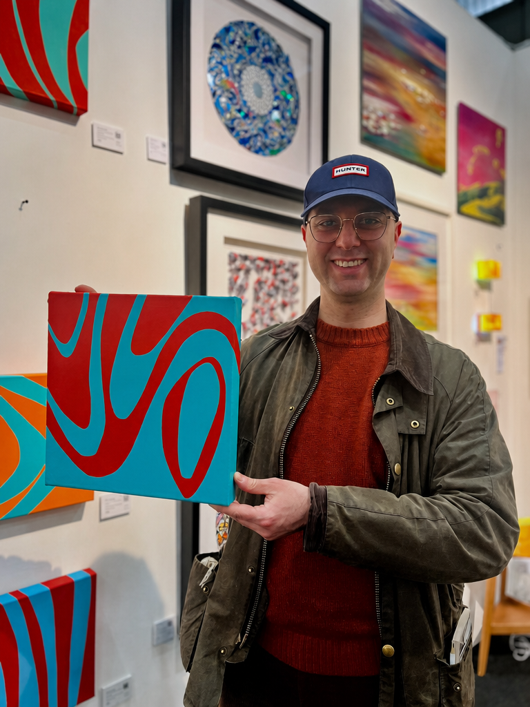 A visitor holding a Kika Pierides painting at Fresh Art Fair