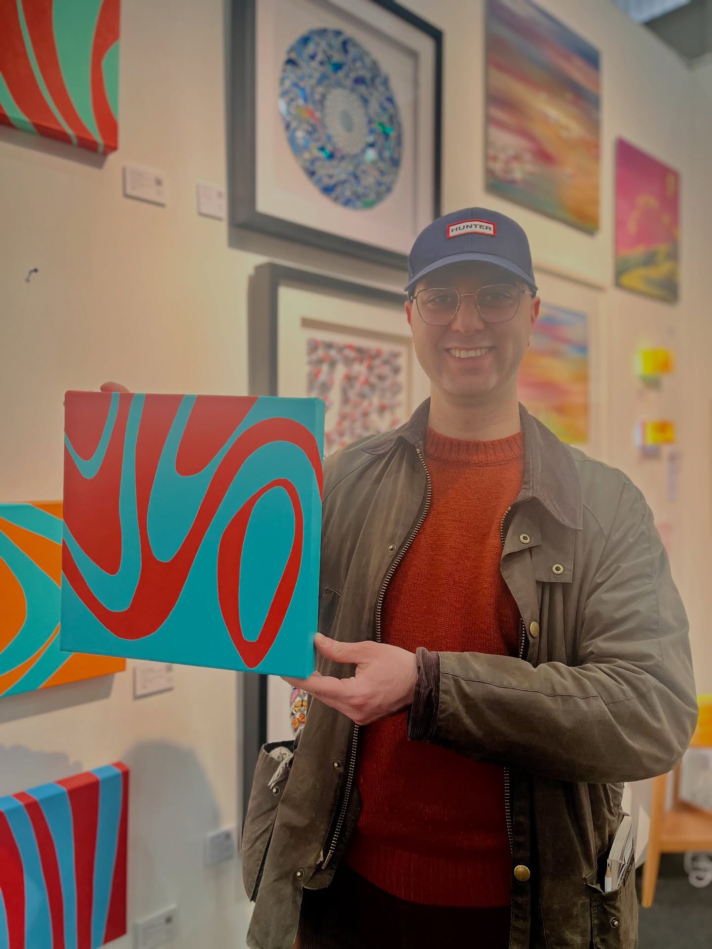 A visitor holding a Kika Pierides painting at Fresh Art Fair