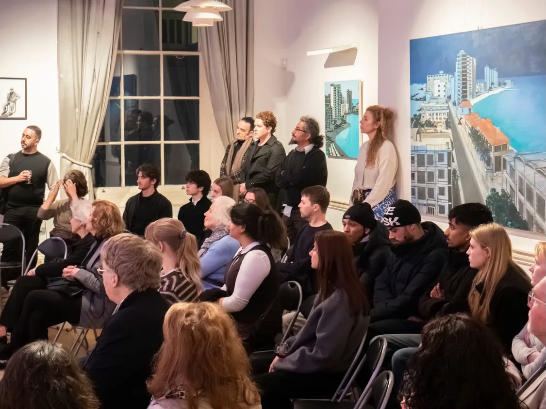 A seated audience during an artist-led gallery tour