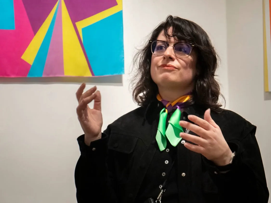 Kika Pierides speaking in front of artwork during the artist-led tour