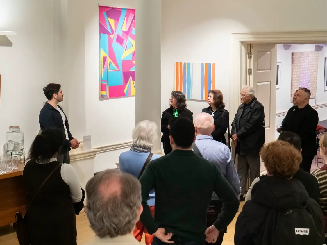 Visitors listening during an artist-led tour of There Is An Island III