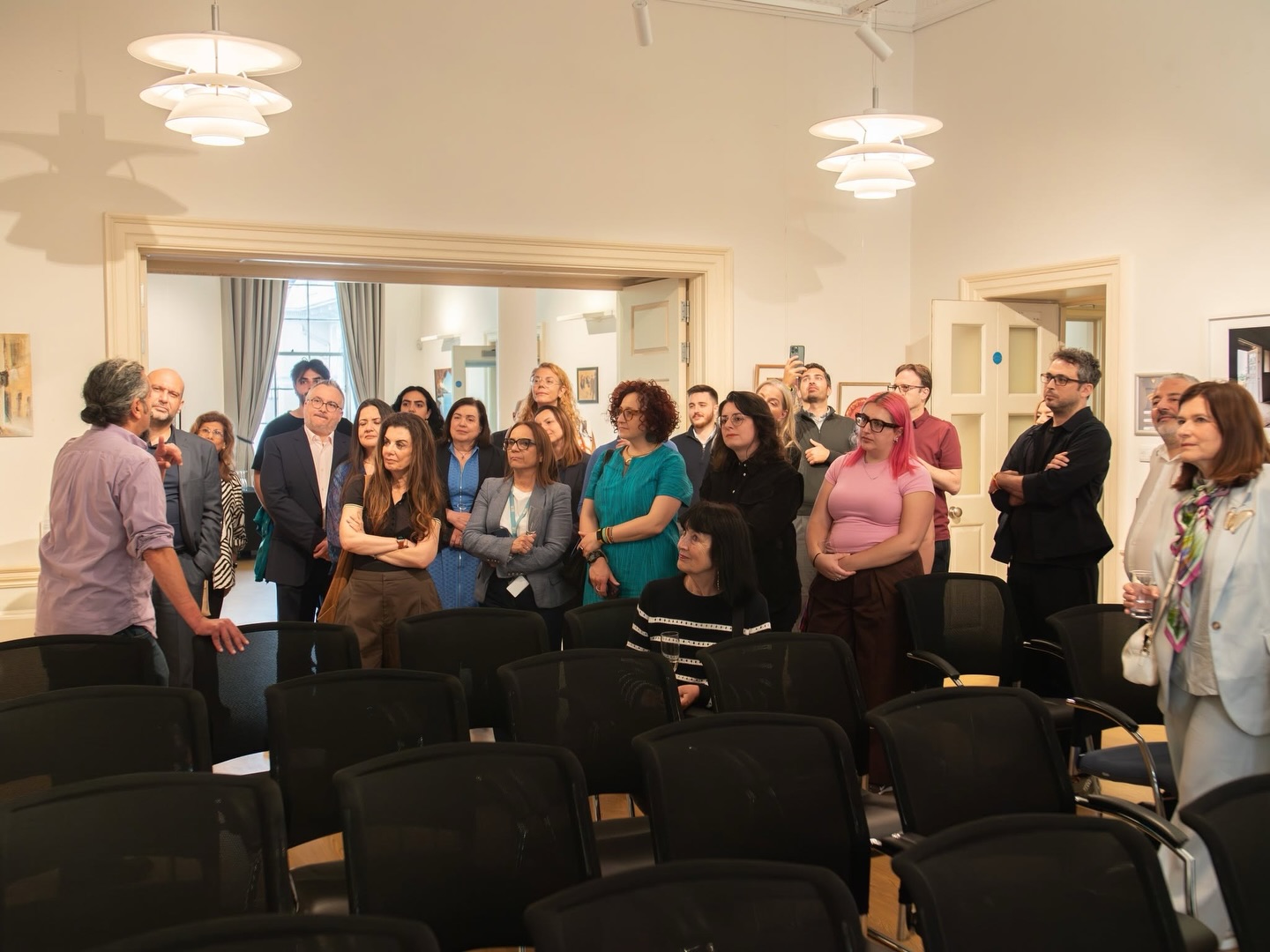 A gallery audience gathered for an event during There Is An Island III