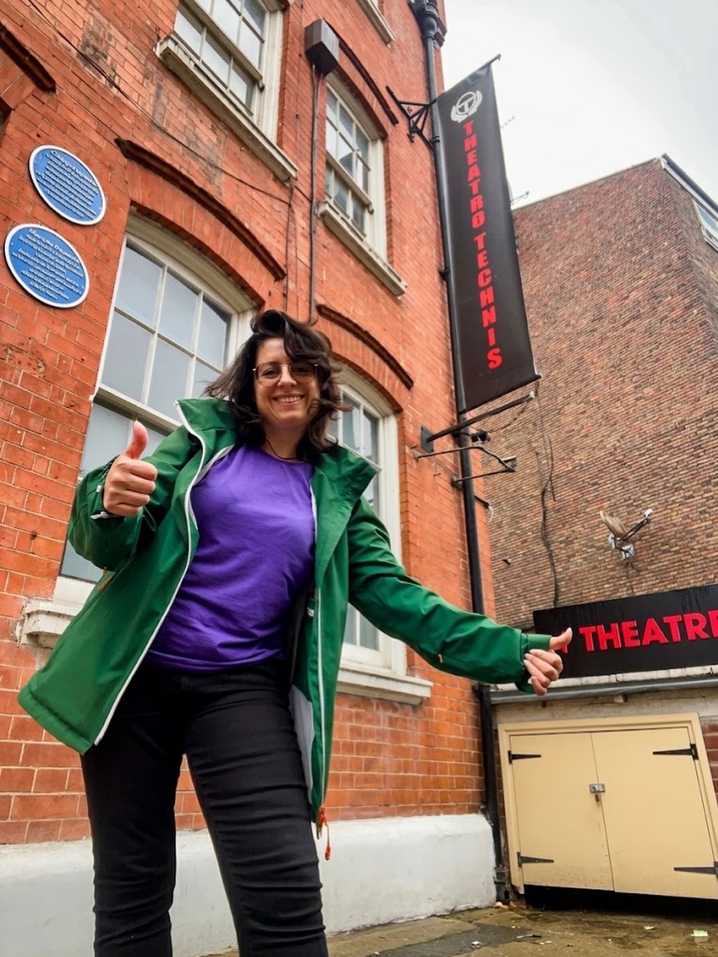 Kika Pierides outside Theatro Technis in front of the theatre sign