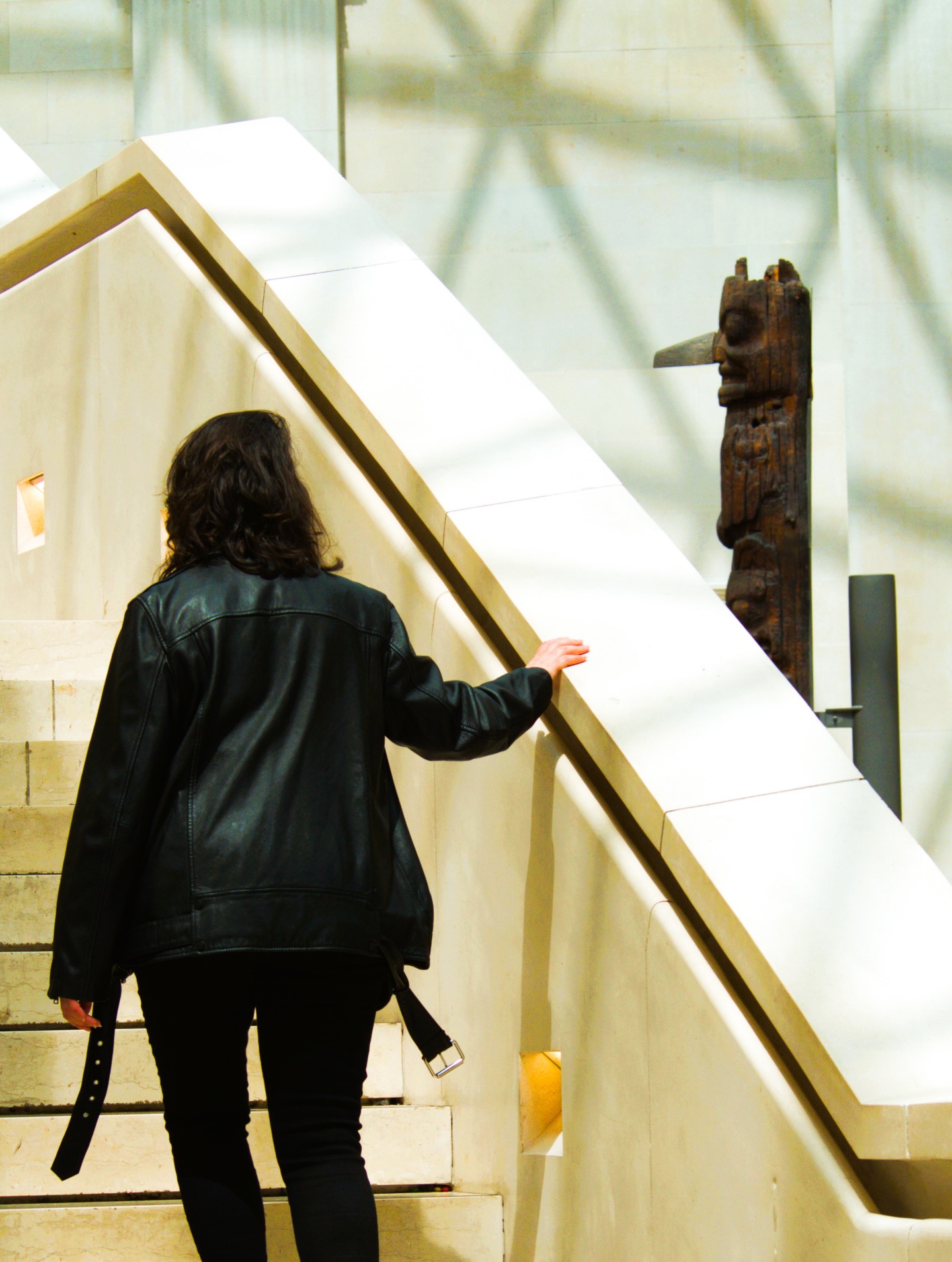Person climbing museum stairs.