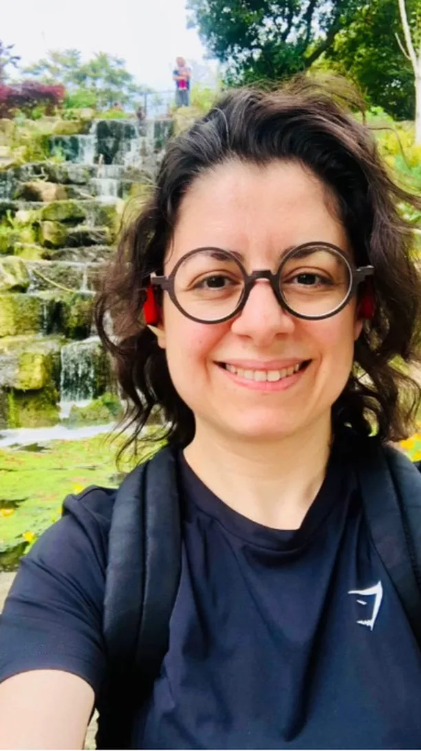 Kika Pierides speaking beside a park for Thoughts On Walks: Ep 18.