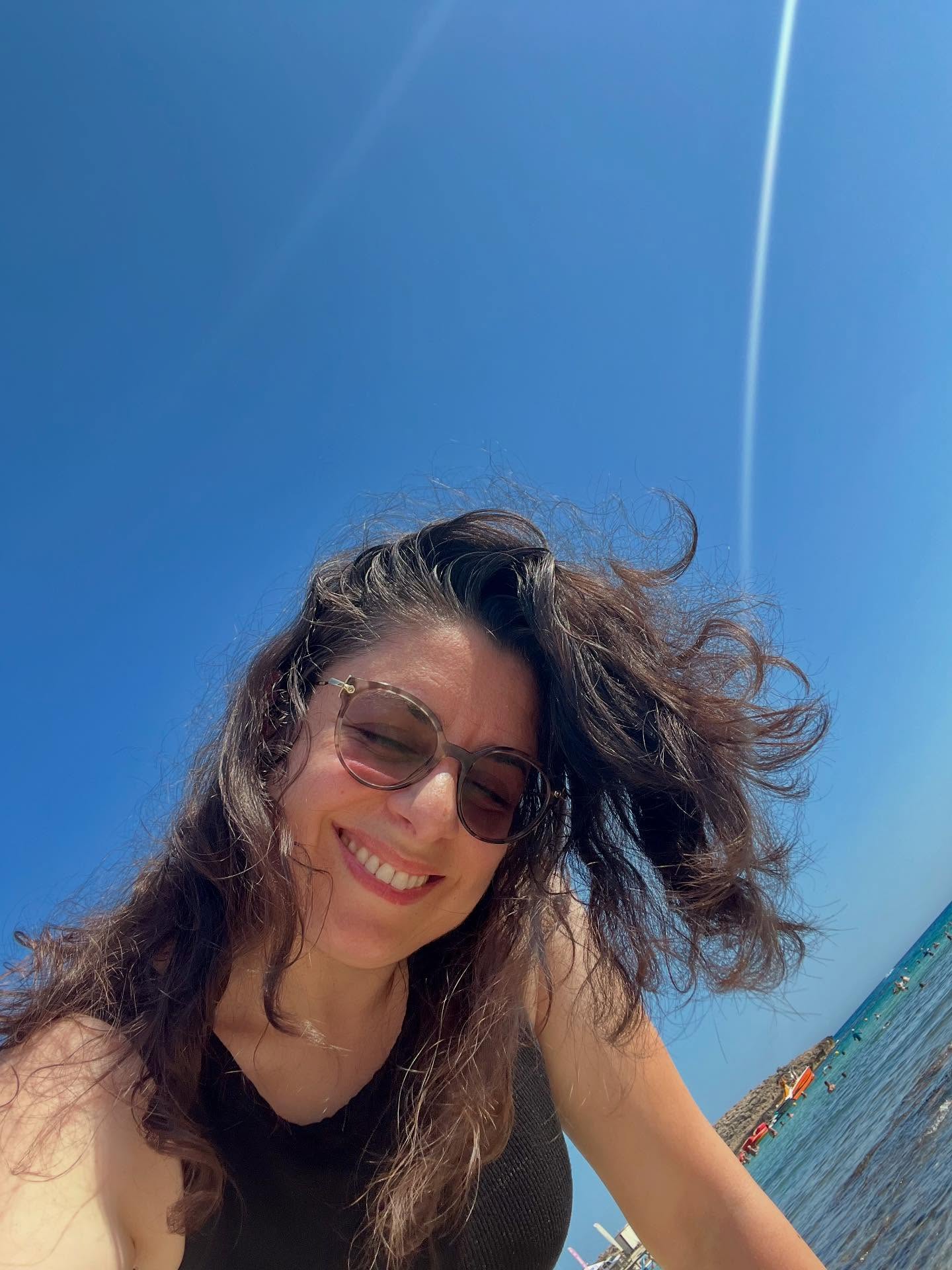 Woman beach selfie sunny.