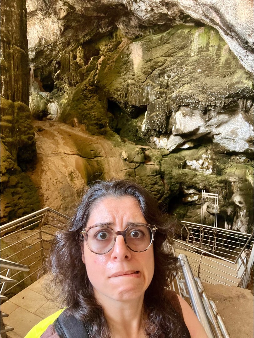 Woman cave entrance selfie.