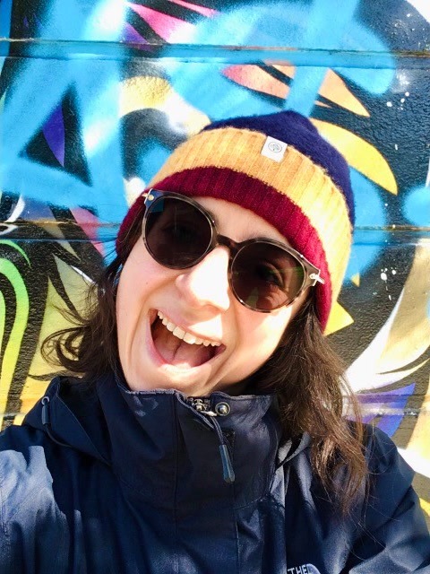 Woman smiling beanie graffiti.