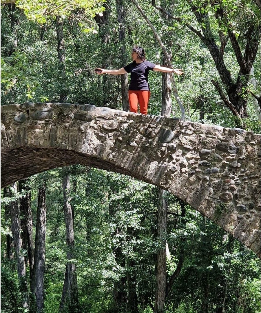 Woman stone bridge forest.