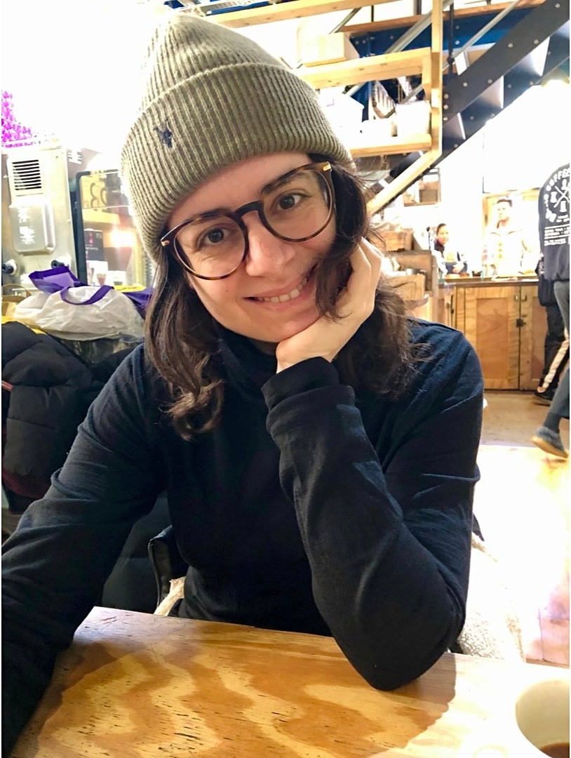 Woman wearing green beanie.