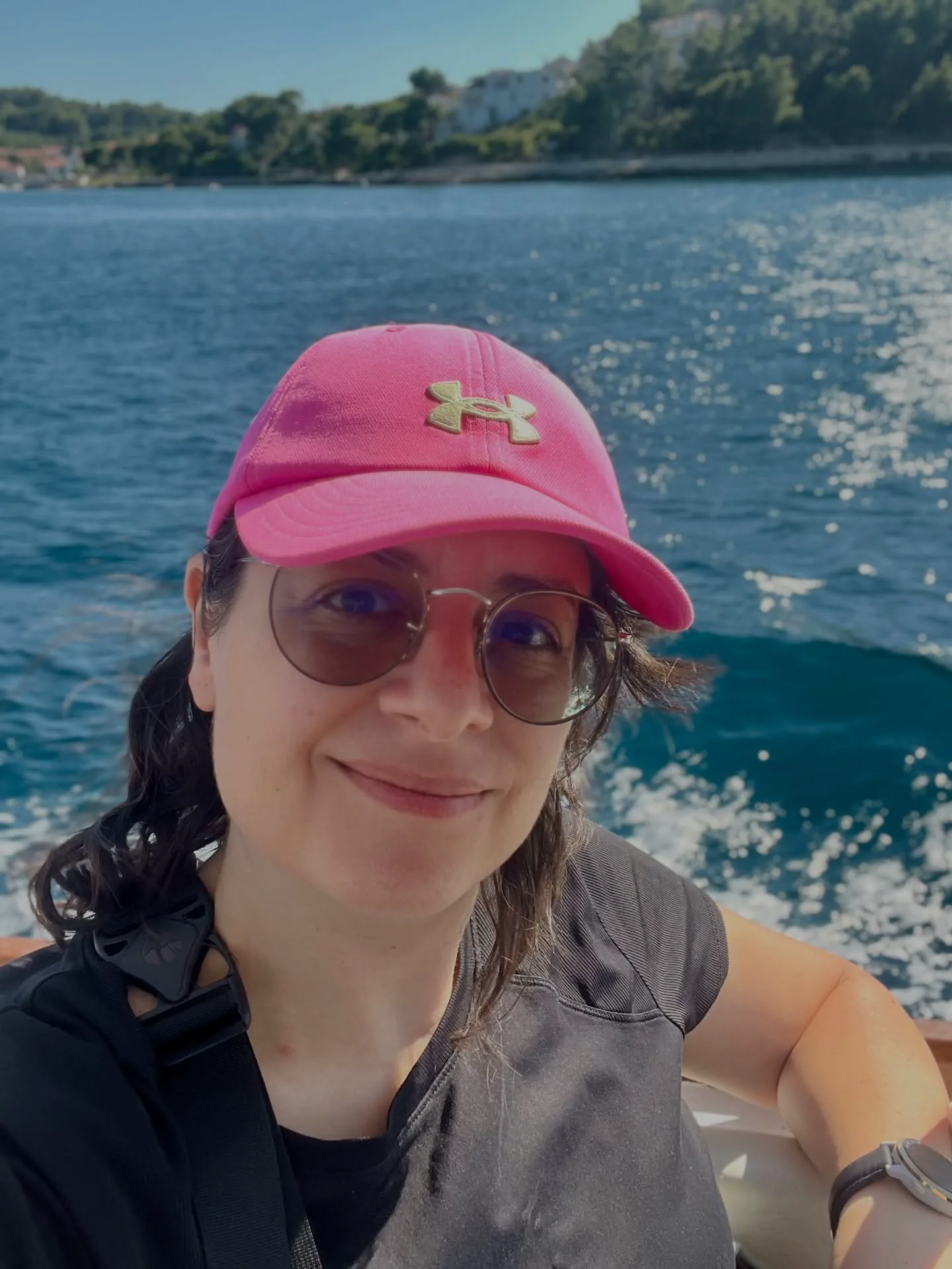 Kika Pierides wearing a pink cap on a boat in Croatia.