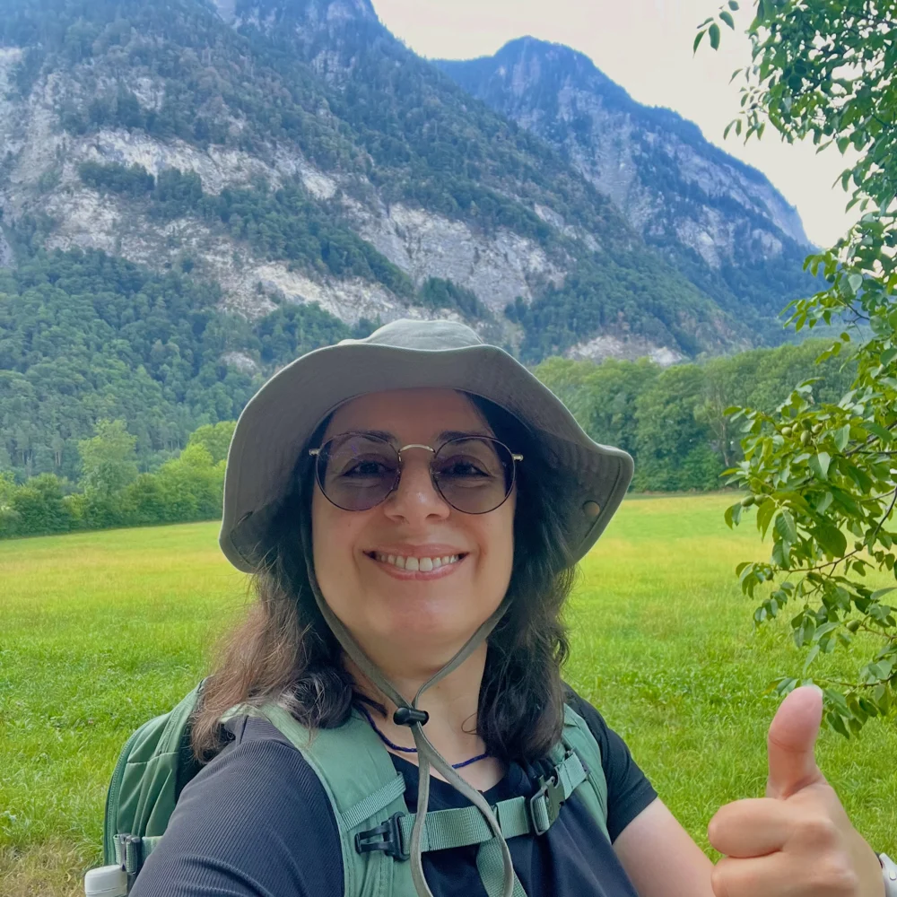 Kika giving a thumbs up while hiking in the mountains of Liechtenstein